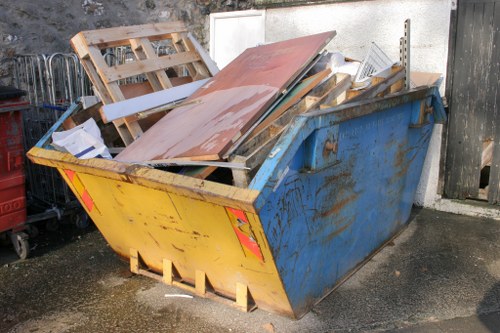 Professional skip hire team assisting a customer